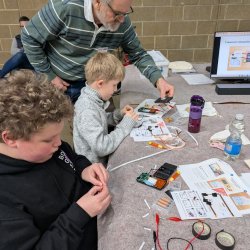 Youngsters engrosed in repairing things.