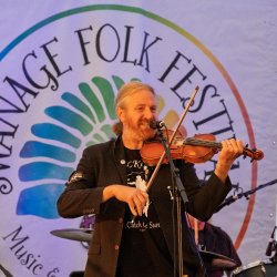 A band on main stage for an evening concert.