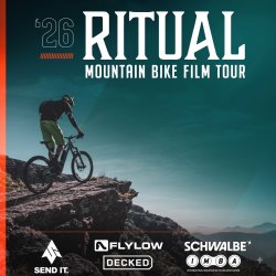 person riding mountain bike on top of a mountain
