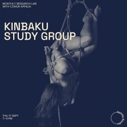 Kinbaku practitioner in an inverted rope suspension against a midnight-blue background.