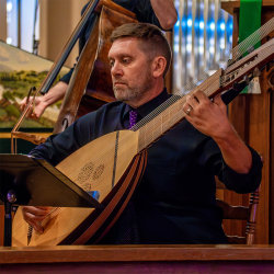 Peter playing theorbo on stage