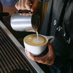 Pouring latte art into a mug