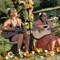 Two people playing guitar and singing