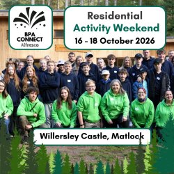A group photo of children, young people and adults who took part in 2024's Alfresco weekend, smiling at the camera and wearing green and blue BPA hoodies