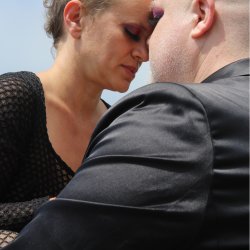 photo of Z & E resting into deep connection touching foreheads, with a blue sky behind them, by Elly Bernstein @fourcubes.photography