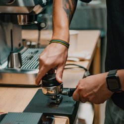 Tamping a portafilter to make espresso