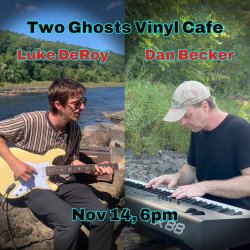 Luke Deroy playing guitar and Dan Becker playing piano on a stone riverside