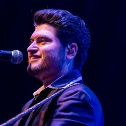 David Thibault au micro avec sa guitare — Elvis & Cie.