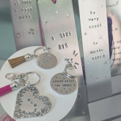 image shows a set of hand-stamped aluminum keyrings