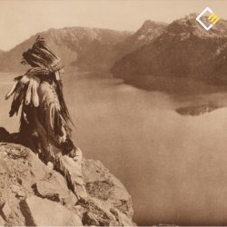 A person in traditional attire sits on a rocky cliff, overlooking a serene lake with mountain peaks in the background. The scene feels contemplative.