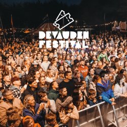 A crowd of people in front of the main stage at the Devauden Festival