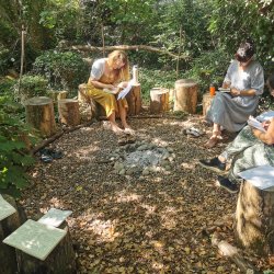 Ladies taking part in haiku writing by our campfire by the river.