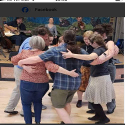Image of 8 people dancing a set and there’s are 3 musicians in the background