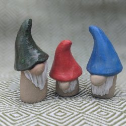 a trio of ceramic gonks