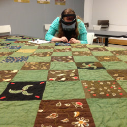 Textile conservator repairing historic quilt