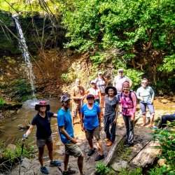 Happy hikers at a hidden waterfall in Iowa