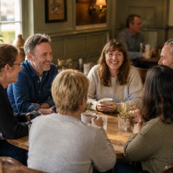 Men and women sat talking and listening in casual environment
