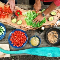 Hands reaching for a board full of fresh ingredients