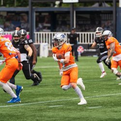 An American football player returns a kick-off at the Britbowl.