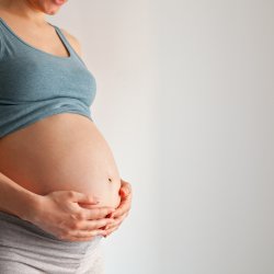 Mother cradling baby bump