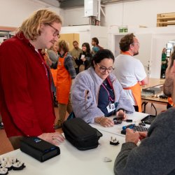 Photo from Haringey Fixing Factory taster day, people repairing electronics together.
