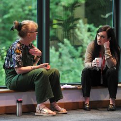 Two people sitting down and talking