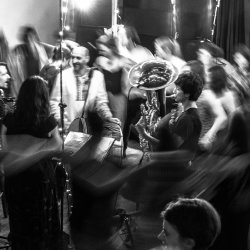 A group of people dancing around a band