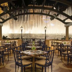 Bellagio dining terrace overlooking the illuminated fountains.