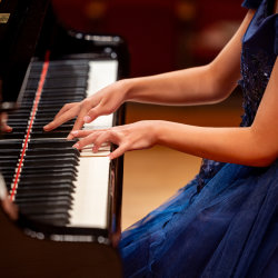 a person's hands playing piano