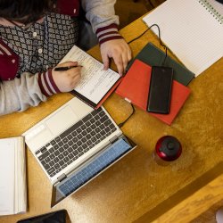 student studying with laptop and notepad
