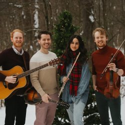 Members of On the Lash standing in snow with backdrop of trees