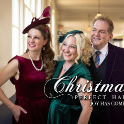 3 singers in festive clothing smiling