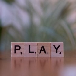 4 game tiles spell out the word PLAY