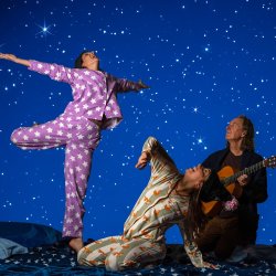 2 performers looking up with a star filled background. 1 performer has a guitar Workshop image credit - Kath Kimber-McTiffen