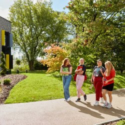 four students walking by STEAM academy
