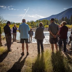 group of people standing by river bank