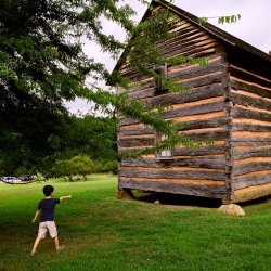 Child pointing at cabin