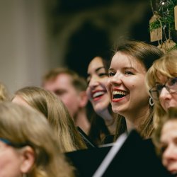 Choir members happily singing in an evening concert