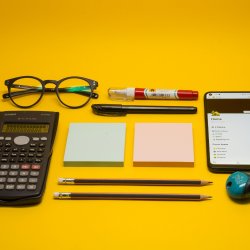 A selection of accounting-related objects on a yellow background