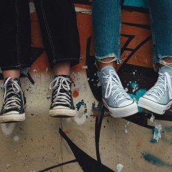 multiple pairs of feet in shoes