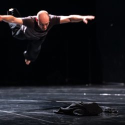 man diving onto stage