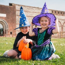 Two girls dressed as witches outside Fort Nelson.