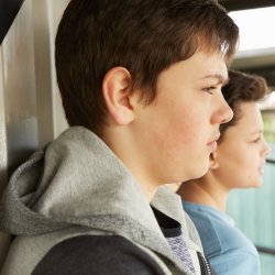 Two kids behind a shelter