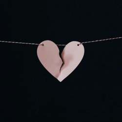 ripped paper heart on a string