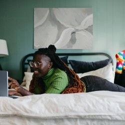 Woman smiling in front of laptop