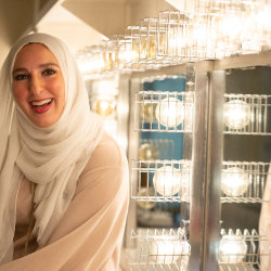 Yasmin Elhady sits in front of a mirror backstage at a theater