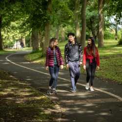 3 students walking along footpath in Woodhouse Moor