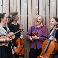 Four women holding string instruments: Emma, Miranda, Grace, Lucy