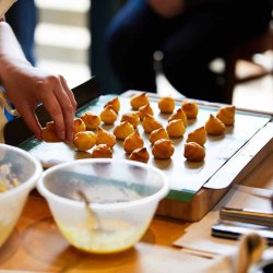 Baked choux pastry on a baking tray at a cookery school