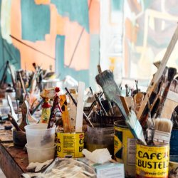 Paint brushes and cans on a table